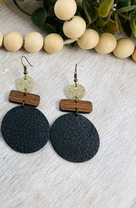 Leather and wood earrings. Leather circle with wood bar accents.