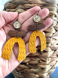 Large arched leather earrings. Gold and mustard.